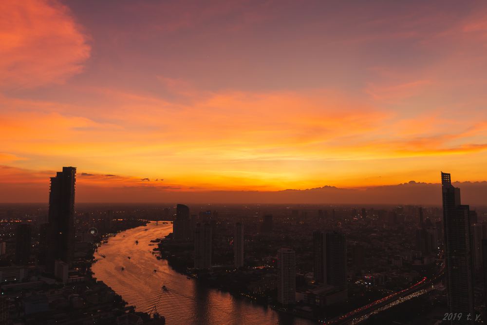Sunset over the Chao Phraya River winding through Bangkok